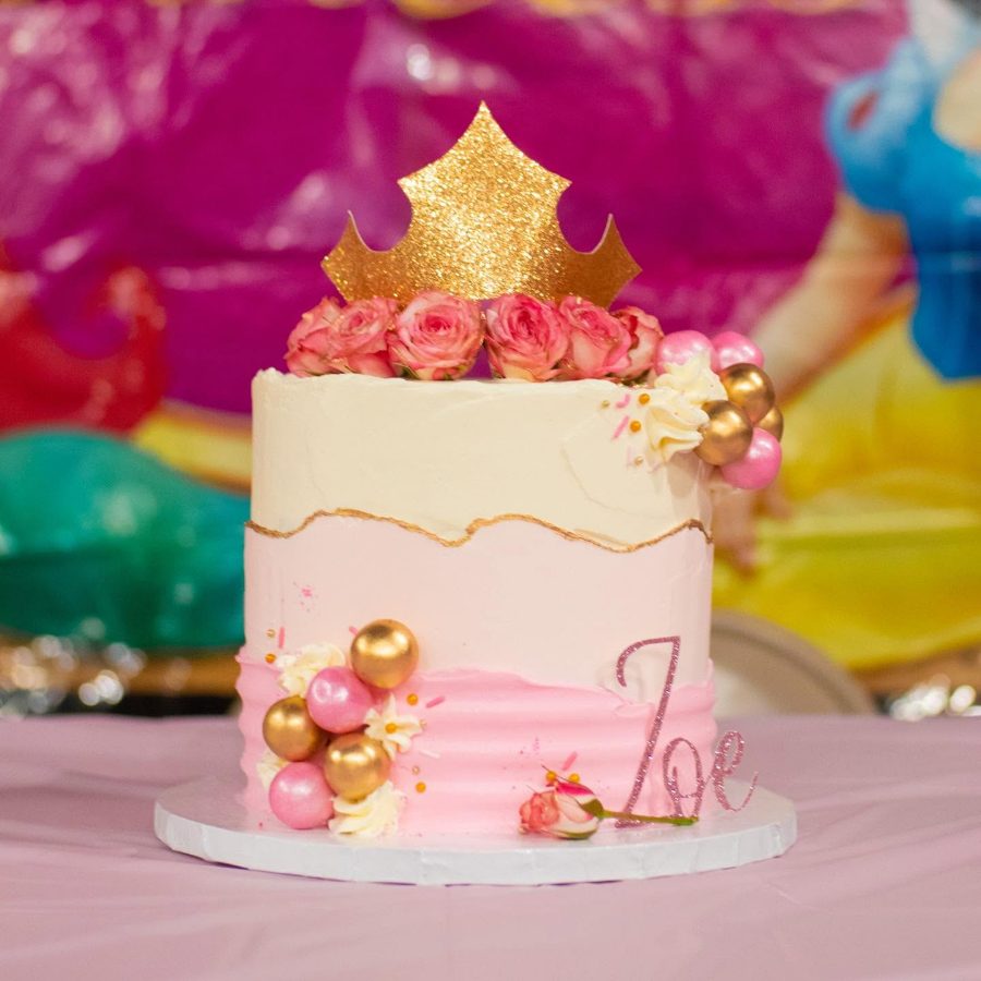 Cakes & Bakes's own photograph: a pink and gold cake with a gold crown on top.